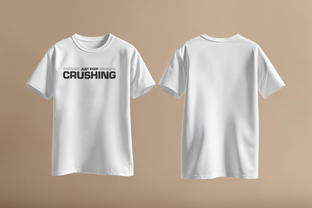 White shirt with bold black font saying Just Keep Crushing across chest