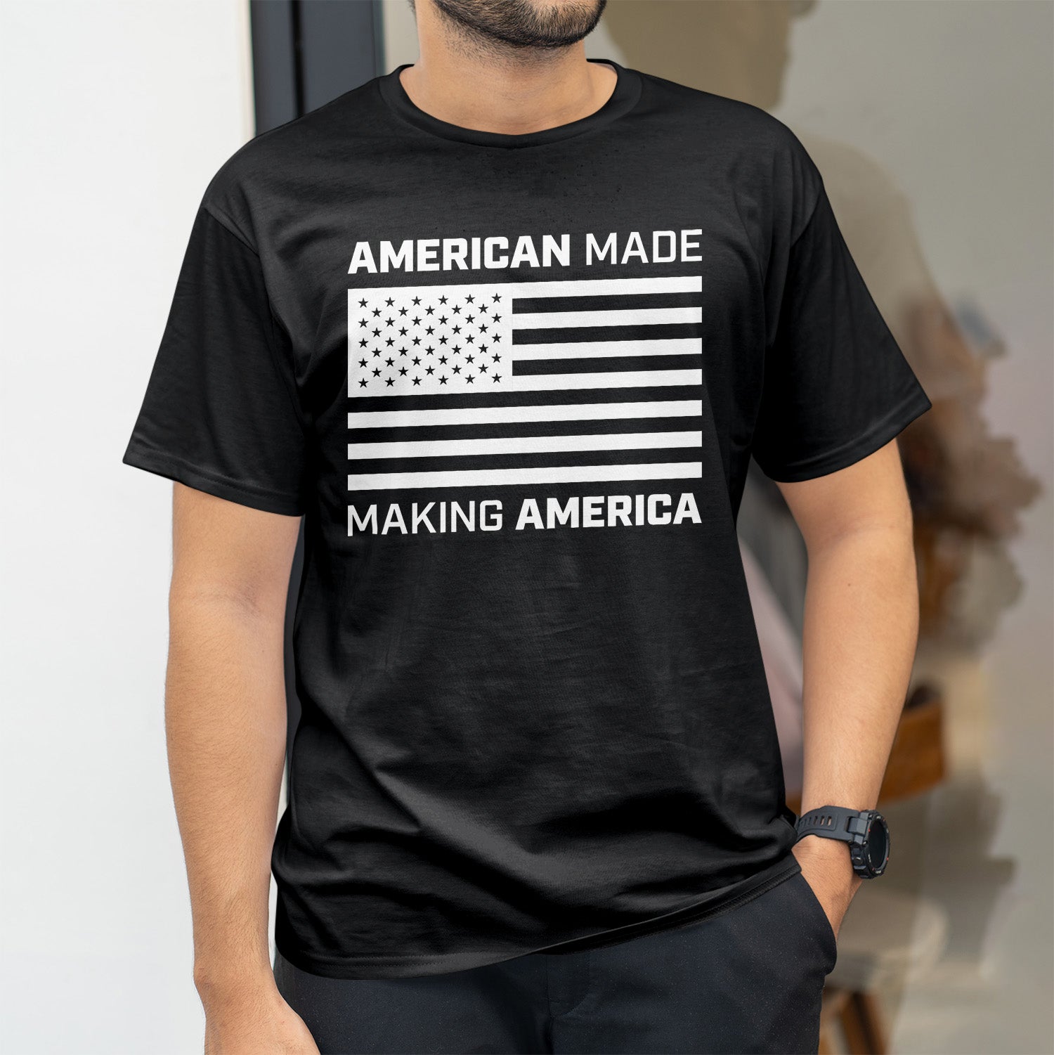 black shirt with American Made Making America in strong white font with American Flag in center of shirt.