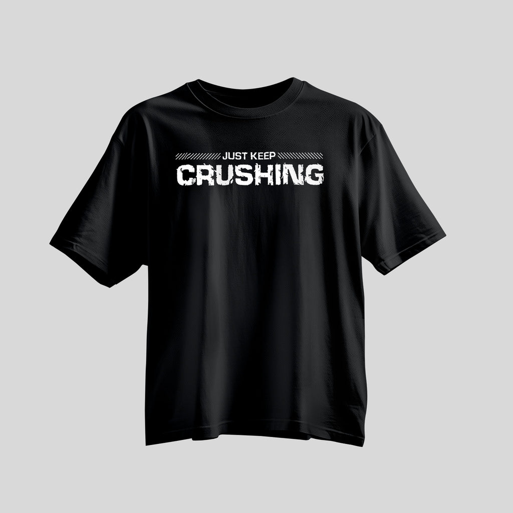 Black shirt with bold white font saying Just Keep Crushing across chest